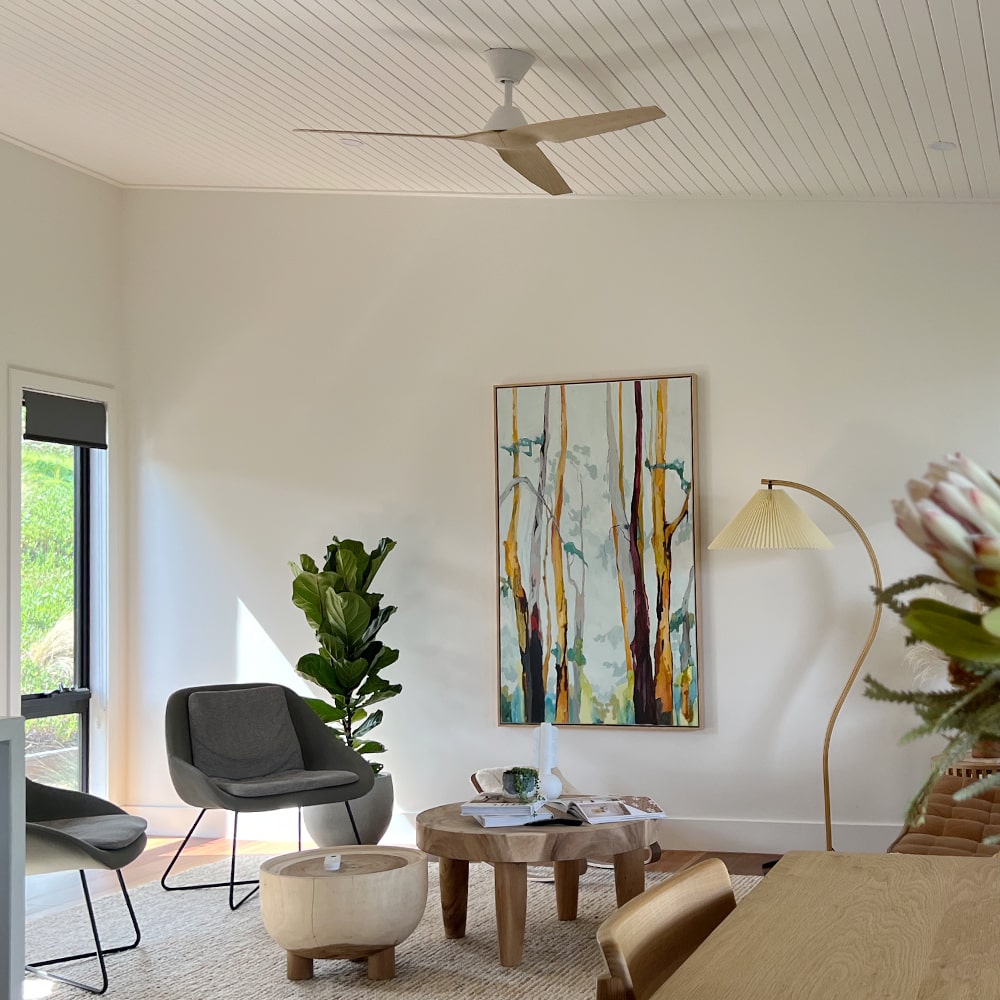 modern infinity ceiling fan in light timber living room
