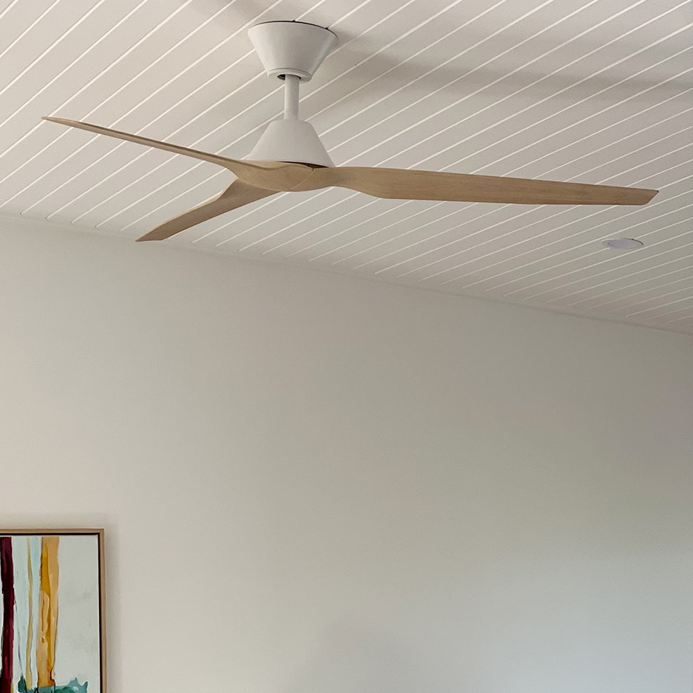close up of fanco infinity dc ceiling fan with light timber blades